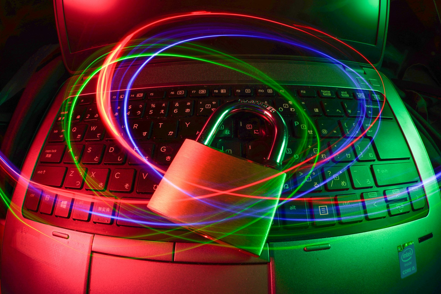 Padlock on a keyboard with light trails